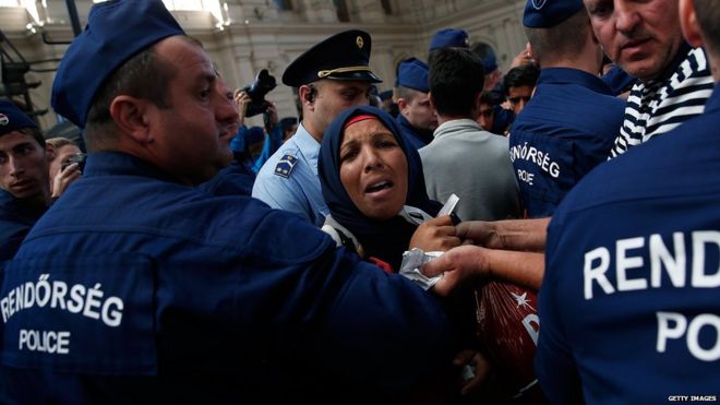 An Iraqi woman struggles with Hungarian police after being separated from her family while attempting to board a train bound for Vienna, Austria at the Keleti railway station on 8 September 2015 in Budapest, Hungary