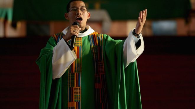 South African priest delivering sermon