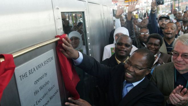 South African Minister of transport Sbu Ndebele unveils a plaque on 30 August 2009 during the official launch of the new Johannesburg Bus Rapid Transit System Rea Vaya