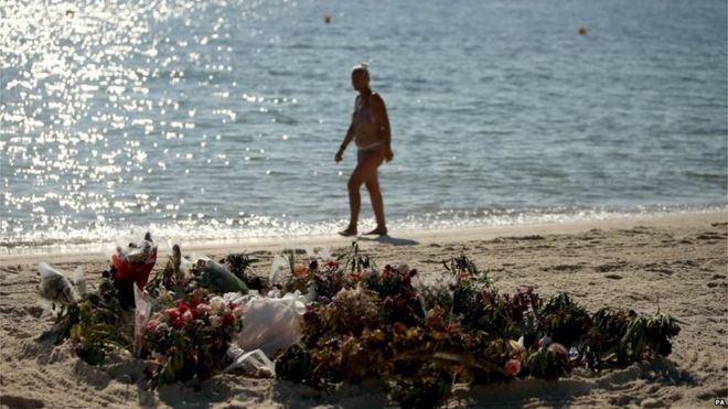 Flowers remain on the beach near the RIU Imperial Marhaba hotel in Sousse, Tunisia, where 38 people lost their lives after a gunman stormed the beach.