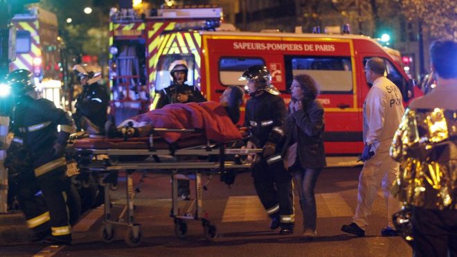 Medics move a wounded man near the Boulevard des Filles-du-Calvaire after an attack on 13 November 2015 in Paris, France