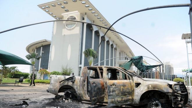 Burned-out cars outside government building in Libreville, Gabon, Sept 1, 2016