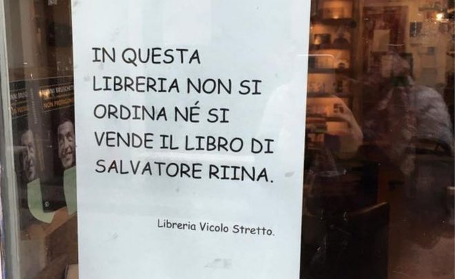 The sign in Italian reading: In this bookshop Salvatore Riina's book will not be ordered nor sold