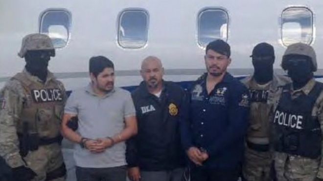 Efrain Antonio Campo Flores (2nd from L) and Franqui Francisco Flores de Freitas stand with law enforcement officers in this November 12, 2015 photo after their arrest in Port Au Prince, Haiti.