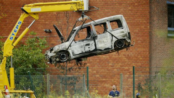 This picture taken on August 29, 2016, shows the burnt car used to ram raid the National Institute for Criminalistics and Criminology (INCC-NICC) overnight in