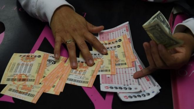 A woman picks up her Powerball lottery tickets in Hawthorne, California. Photo: 13 January 2015