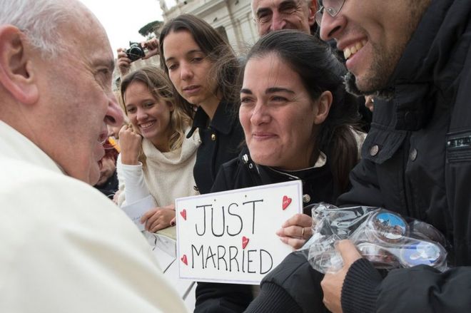 Pope Francis greets a newly married couple at the Vatican, 23 March