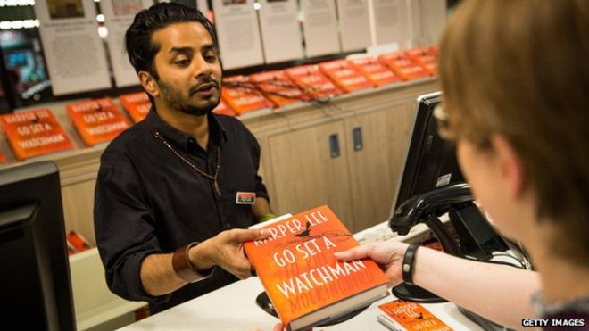 A customer buying Go Set a Watchman at Foyles book shop in London