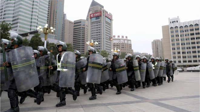 Armed paramilitary policemen run in formation during a gathering to mobilize security operations in Urumqi, Xinjiang Uighur Autonomous Region, in this June 29, 2013