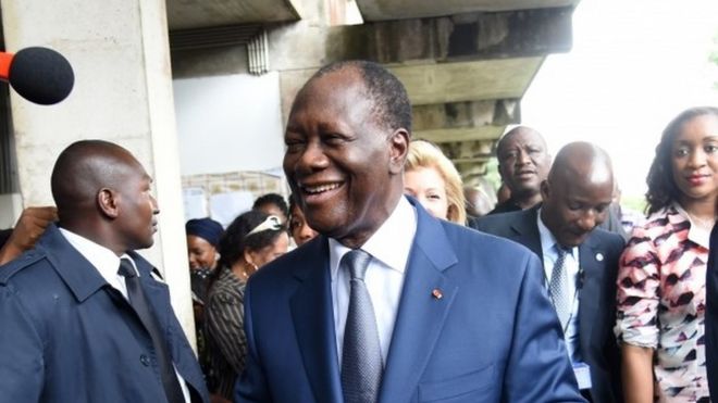 Ivory Coast president Alassane Ouattara leaves a polling station after voting in Abidjan during Ivory Coast presidential elections