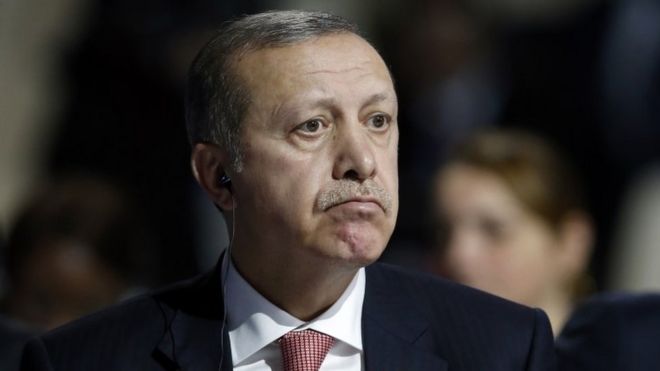 Turkey's President Recep Tayyip Erdogan listens to statements at the COP21, United Nations Climate Change Conference, in Le Bourget, outside Paris, on Monday