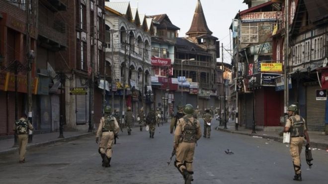Indian paramilitary soldiers patrol a deserted street during curfew in Srinagar, Indian controlled Kashmir, Tuesday, Sept. 13, 2016.
