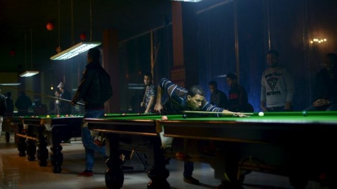 Men play billiards in a billiard hall in Benghazi, Libya January 30, 2016