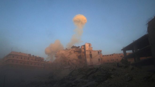 Smoke rises from a damaged building after a strike on the rebel-held besieged al-Shaar neighbourhood of Aleppo