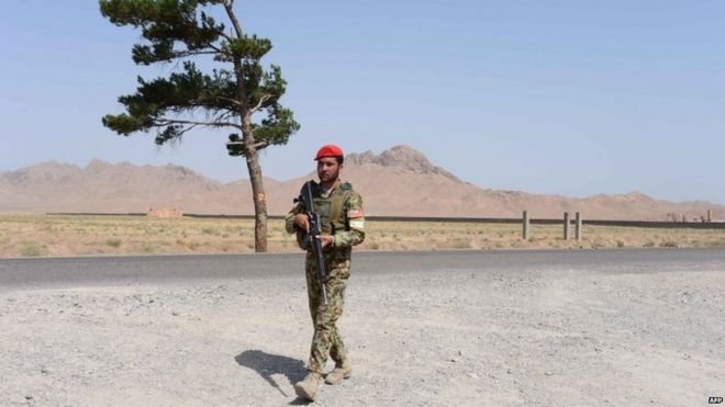 An Afghan National Army soldier walks on the outskirts of Herat (29 June 2015)