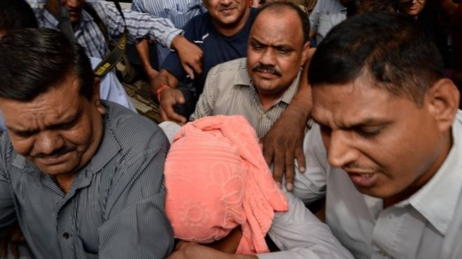 Indian policemen escort the juvenile (C, in pink hood), accused in the December 2012 gang-rape