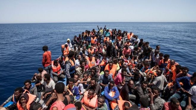 Boat crammed with migrants at sea