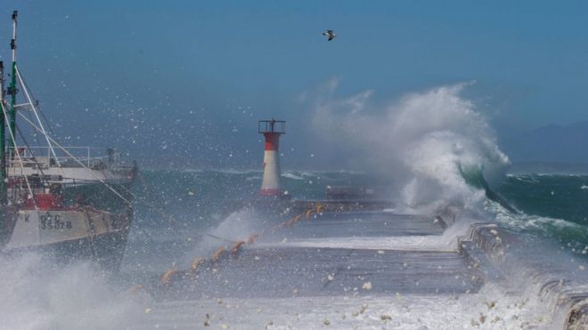 Waves break over the Kalk Bay Harbour wall in Cape Town, South Africa, 14 November 2061. The effect of the supermoon with massive tidal range has combined with a gale force wind and big swell to create this extreme weather phenomenon.