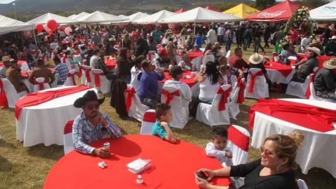 People sit at tables at Rubi's birthday party in La Joya, Mexico. Photo: 26 December 2016