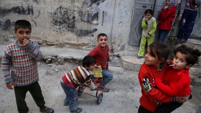Syrian children play outside their home in the rebel-held neighbourhood of Tishreen, after a ceasefire that went into effect in Damascus, Syria (27 February 2016)