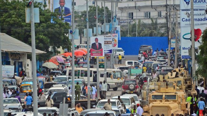 Traffic in Somalia's capital, Mogadishu, on streets with election campaign poster - December 2016