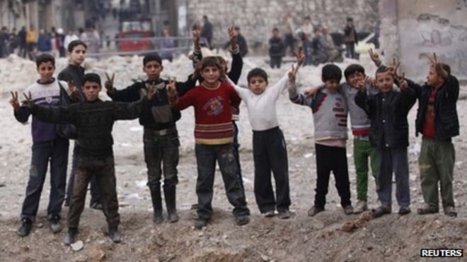 Syrian children flash victory signs