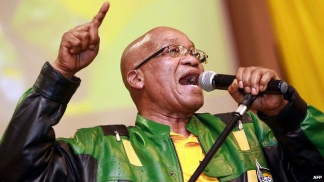 South African President t Jacob Zuma leads hundreds of supporters in singing a song during a campaign event at the Inter-fellowship Church in Wentworth township, outside of Durban, on 9 April 2014