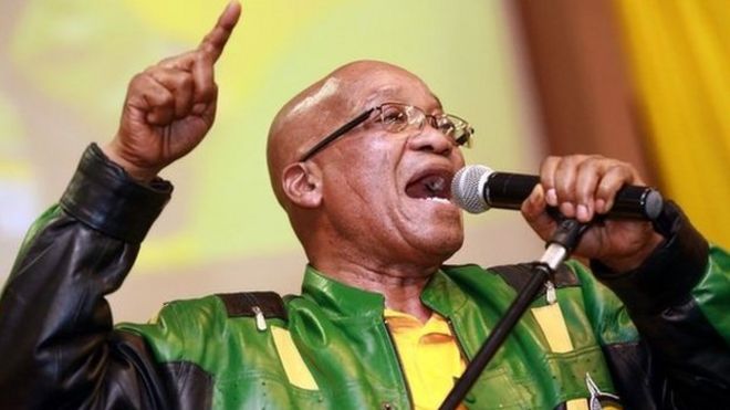 South African President t Jacob Zuma leads hundreds of supporters in singing a song during a campaign event at the Inter-fellowship Church in Wentworth township, outside of Durban, on 9 April 2014