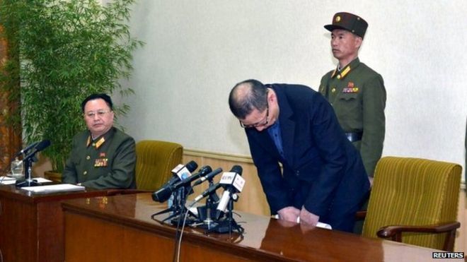 One of the two men arrested in North Korea bows during a news conference in this undated photo released by North Korea's Korean Central News Agency (KCNA) in Pyongyang on 26 March 2015