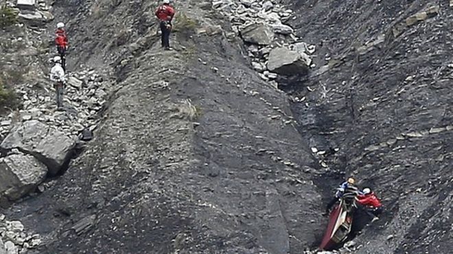 Rescue workers work on debris at the plane crash site near Seyne-les-Alpes, France. 25 March 2015
