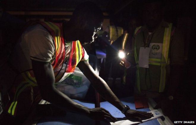 Election officials start the counting process at a polling station in Yenagoa on 28 March