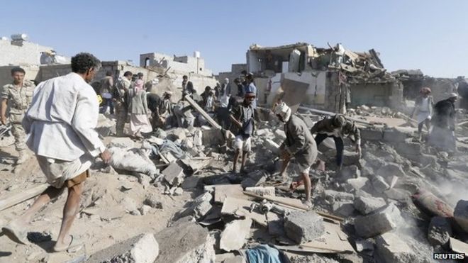 People search for survivors under the rubble of houses destroyed by an air strike near Sanaa Airport (25 March 2015)