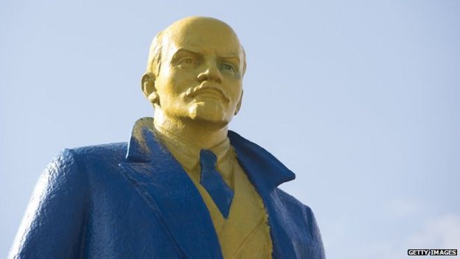 A statue of Lenin painted in blue and yellow