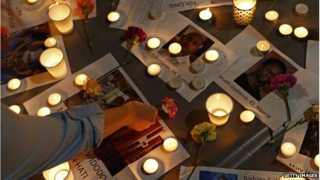 A woman places a flower on top of pictures of some of the prisoners to be executed in Indonesia during a vigil at Martin Place on 28 April 2015 in Sydney, Australia.