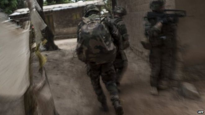 French troops patrol to secure an area after exchanges of gunfire during a disarmament operation in the Combattant neighbourhood near the airport of Bangui, on December 9, 2013.