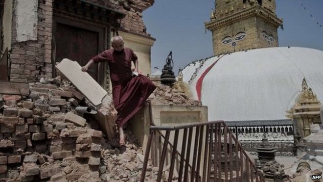 A Buddhist monk walking over the rubble of a temple in Kathmandu. Photo: 2 May 2015