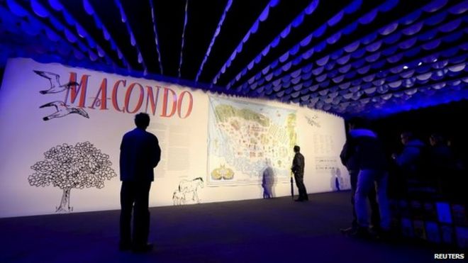 Visitors look at an exhibit at the entrance of the Macondo pavilion during Bogota's 28th International Book Fair on 22 April, 2015.