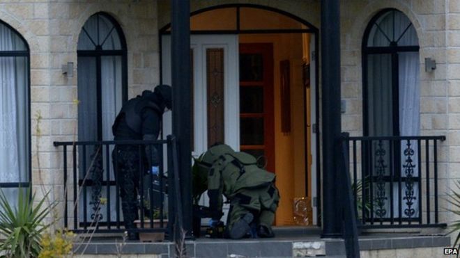Officers wearing bomb suits raid a house in Greenvale, Melbourne, Australia, 8 May 2015
