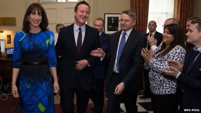 David Cameron is welcomed back to Downing Street by No 10 Cabinet Secretary Sir Jeremy Heywood and other staff