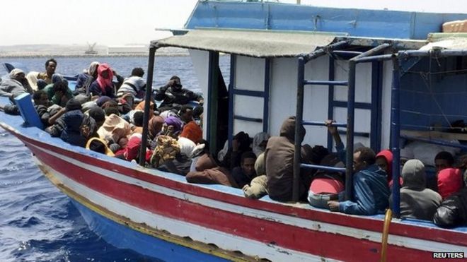 Migrants who attempted to sail to Europe sit in a boat carrying them back to Libya after their boat was intercepted at sea by the Libyan coast guard, at Khoms, Libya, 6 May 2015