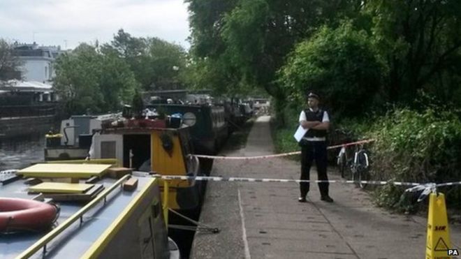 Policeman standing by the canal