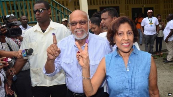 Guyana President Donald Ramotar and first lady Deolatchmee show their ink-stained fingers after voting in the general elections, in Georgetown, Guyana, Monday, May 11, 2015.