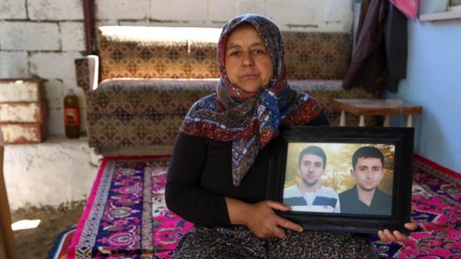 Sevim Cata holds a photograph of her two sons, Suleyman and Ismail. May 2015