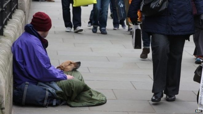 Homeless man on a London street with his dog. 01/04/2015.