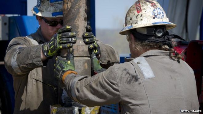 Workers change pipes at Consol Energy Horizontal Gas Drilling Rig exploring the Marcellus Shale outside the town of Waynesburg, Pennsylvania