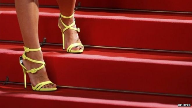 The shoes of an unidentified guest are pictured as she poses on the red carpet for the screening of The Lobster at the Cannes Film Festival