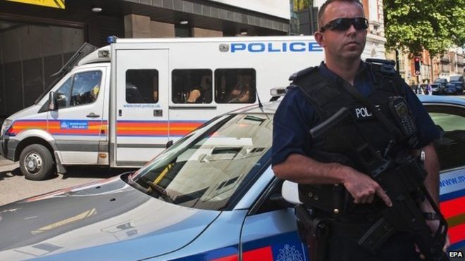 Eight men arrive under police escort to Westminster Magistrates Court,