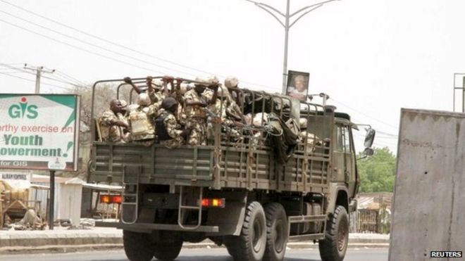 Soldiers are seen on a truck along a road in Maiduguri in Borno State, Nigeria 14 May 2015