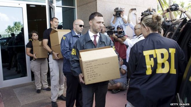 FBI investigators remove documents after the arrests of several senior Fifa officials