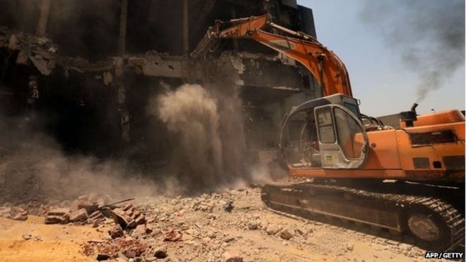 A bulldozer destroys the building of the headquarters of the once-dominant party of ex-president Hosni Mubarak that was torched during the 2011 uprising that toppled him on 31 May 2015 in Cairo.